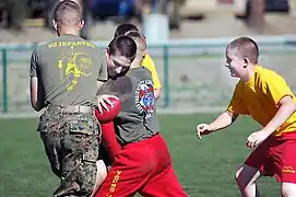 Young Marines of the Saddleback Raiders unit, Camp San Mateo, Marine Corps Base Camp Pendleton, Calif., play two-hand touch football during their day aboard Camp Pendleton.