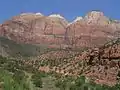 Bee Hive Peak (left) with The Streaked Wall featured. Note the white Navajo Sandstone of the beehive shaped summit. The peak to right is The Sentinel.