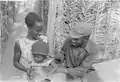 PAIGC soldier with his family in a military camp, 1974.