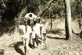 Armed escort carries a wounded person from Sara to the Senegalese border, 1974.