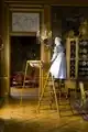 A housemaid cleaning a chandelier with a 'prism trap', early 20th century homemuseum Stockholm Sweden